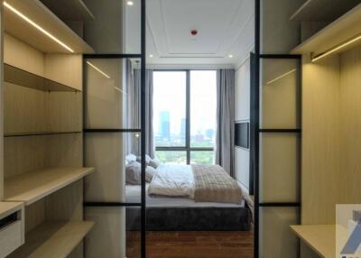 Modern bedroom with large windows and built-in storage