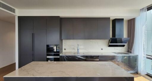 Modern kitchen with black cabinets and marble counters