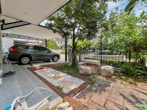 Outdoor carport area with surrounding greenery