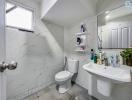 Modern bathroom with white tiles, sink, and toilet