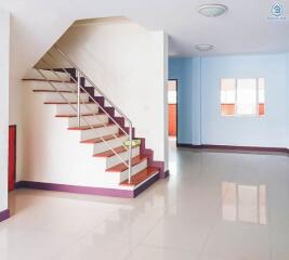 Main living area with staircase and bright open space