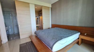 Modern bedroom with wooden furniture and grey bedding