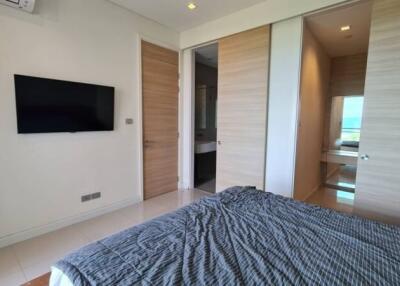 Modern bedroom with TV and bathroom access
