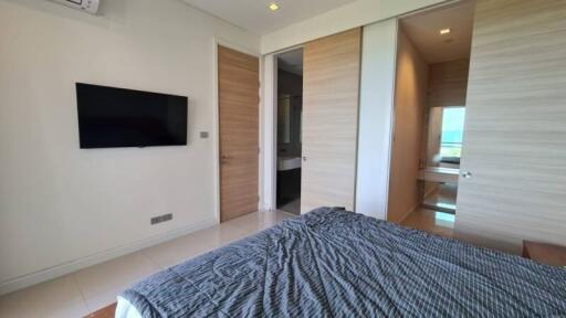 Modern bedroom with TV and bathroom access