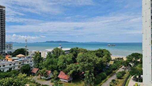 A scenic view of the ocean from a high-rise apartment balcony