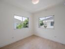 empty bedroom with large windows and wooden floor