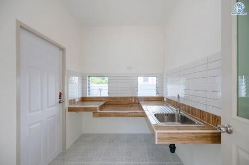 Modern kitchen with tiled walls and wooden countertops