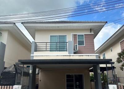 Front view of a two-story house with covered parking