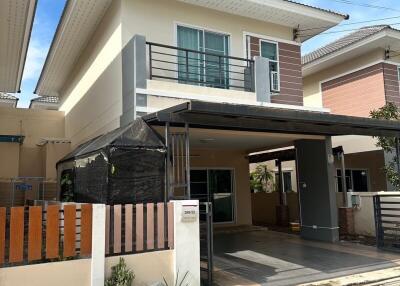 Exterior view of modern two-story house with covered carport and balcony