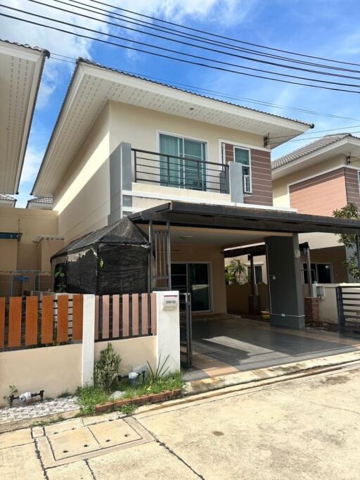 Exterior view of modern two-story house with covered carport and balcony