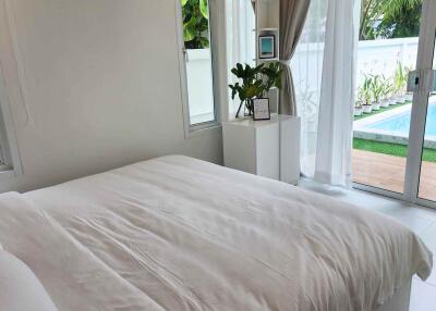 Bedroom with a view of a pool