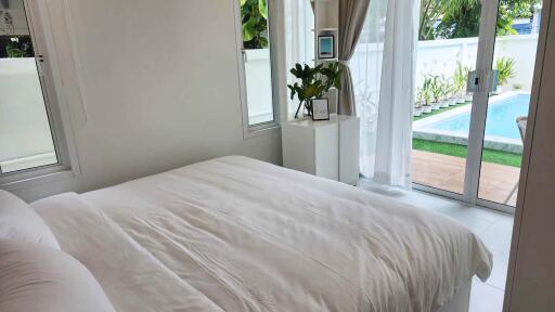 Bedroom with a view of a pool