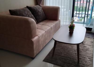 Cozy living room with a sofa and coffee table by a window