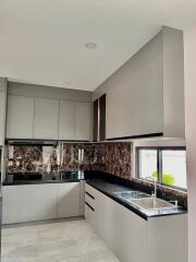 Modern kitchen with marble backsplash and ample storage