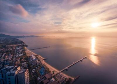 Aerial view of coastal area with buildings and piers at sunset