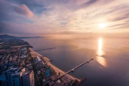Aerial view of coastal area with buildings and piers at sunset