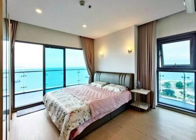 Modern bedroom with large windows and ocean view
