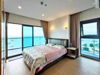 Modern bedroom with large windows and ocean view