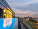 Rooftop pool with a scenic city and mountain view at sunset