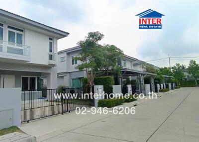 Street view of modern residential houses with gated fences