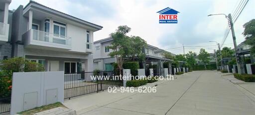 Street view of modern residential houses with gated fences