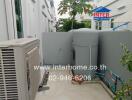 Outdoor utility area with HVAC unit and water tank
