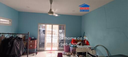 Bedroom with clothes rack and sliding glass door