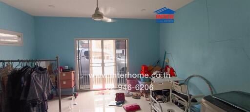 Living area with blue walls and various items scattered