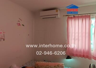 Bedroom with air conditioning and pink curtains