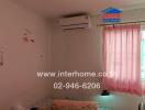 Bedroom with air conditioning and pink curtains