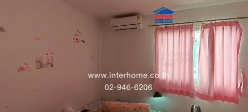 Bedroom with air conditioning and pink curtains