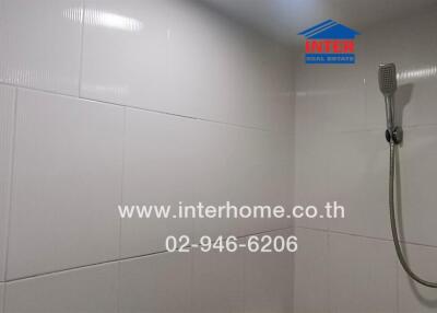 Bathroom with white tiles and shower