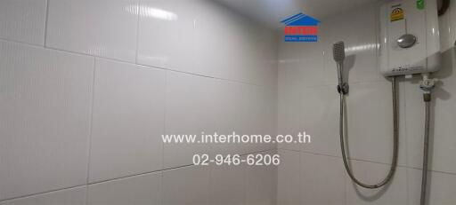Bathroom with white tiles and shower