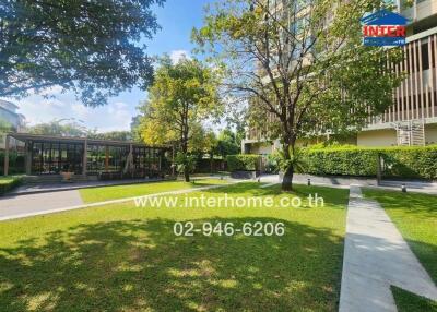 Outdoor garden area of a residential building with pathways and trees