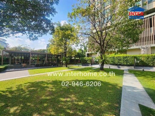 Outdoor garden area of a residential building with pathways and trees