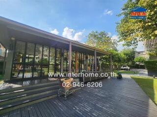 Outdoor view of a building with wooden deck and greenery