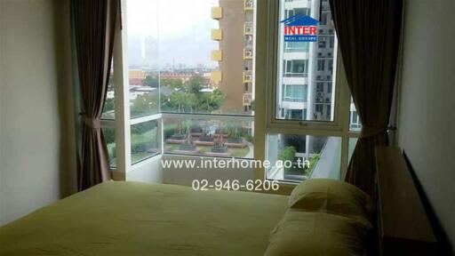 Bedroom with a large window and city view