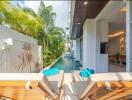 Outdoor patio with sun loungers and pool view