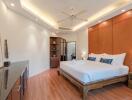 Spacious bedroom with modern lighting and wooden flooring