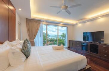 Modern bedroom with large window view and contemporary furnishings