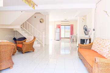 Spacious living room with wicker furniture and bright natural light