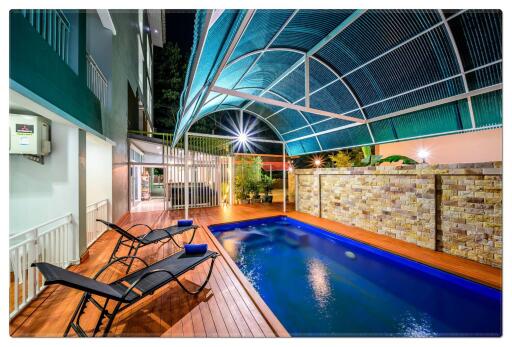 Covered outdoor pool area with seating