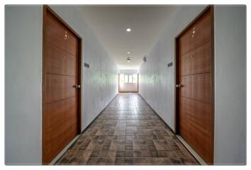 Hallway with two wooden doors and tiled floor