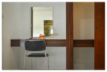 Bedroom with wall mirror and chair