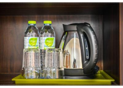 Water bottles and electric kettle on a tray