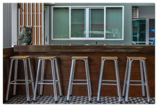 Bar area with wooden counter and stools