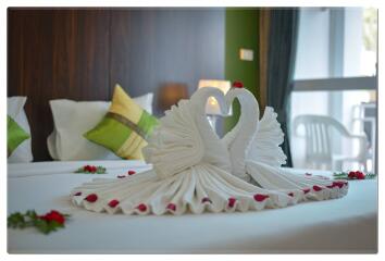 Decorative swan towel arrangement on a bed in a bedroom