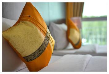 Close-up view of bed with decorative pillows