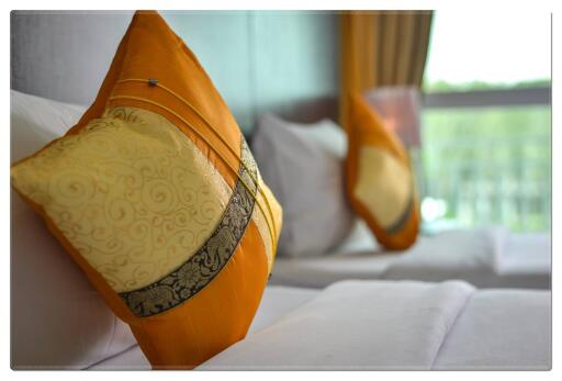 Close-up view of bed with decorative pillows