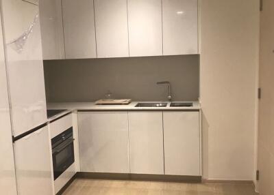 Modern white kitchen with cabinets, sink, and built-in appliances